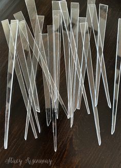 several pieces of clear plastic sitting on top of a wooden table