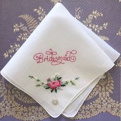 "One of a kind new and unused hand embroidered 'Bridesmaid' vintage cotton lawn handkerchief. This delightful handkerchief is made from 100% white Swiss fine cotton lawn. The handkerchief depicts a machine embroidered pink rose with little white and yellow flowers in one corner. Roses are often portrayed in literature and art as symbols of love and prosperity. The sides of the handkerchief are plain and finished off with machine edging. I have used 100% colour fast contrasting pink embroidery th Vintage Pink Handkerchiefs For Wedding, Vintage Pink Wedding Handkerchiefs, Vintage Floral Embroidery Wedding Handkerchiefs, Traditional Wedding Handkerchiefs With Embroidered Border, Vintage Embroidered Wedding Handkerchiefs, Vintage Embroidered Handkerchiefs For Wedding, Vintage Wedding Handkerchiefs With Machine Embroidery, Embroidered Pink Handkerchiefs For Wedding, Pink Embroidered Handkerchiefs For Wedding