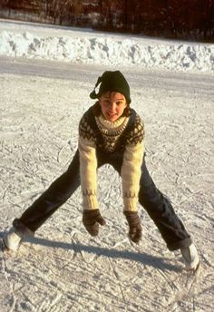 a person riding a snow board on a snowy surface