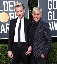 two women standing next to each other on a red carpet