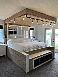 a bed with lights hanging from it's headboard and foot board in a bedroom