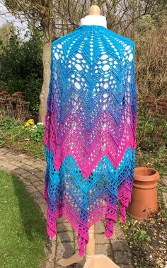 "This shawl is absolutely stunning! It has elicited much admiration from the crochet group I belong to. Made with 4 strands of fine cotton worked  together, the colour changes gradually from turquoise to purple to pink. This in itself is lovely but the pattern used is also spectacular. Look closely at the photos to see the intricate design and the ridges created that accentuate the pattern. This is a delicate work of art and took many hours to make. The shawl measures 44\" from top to bottom and about 88\" across. The yarn, being made of 50% cotton and 50% acrylic, is fine but has a bit of weight to it which makes it hang beautifully. Hand washable at 30 degrees, air dry and reshape whilst damp. With thanks to Katia Löffler for her Is Breá pattern." Handmade Bohemian Pink Patterns, Pink Crochet Lace Shawl In Bohemian Style, Bohemian Pink Shawl With Crochet Lace, Pink Bohemian Shawl With Crochet Lace, Bohemian Pink Shawl For The Beach, Crochet Shawl Wrap, Turquoise Rose, Crochet Shawls And Wraps, Shawl Wrap