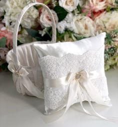 a white wedding ring pillow on top of a table