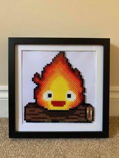 the pixel art is framed in a black frame with a white wall behind it and a brown floor