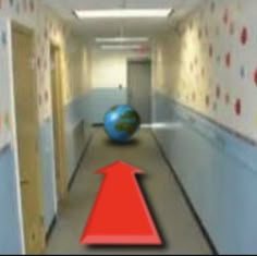 a red arrow going down a hallway with wallpaper on the walls and a blue ball in the foreground