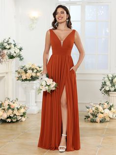 a woman wearing an orange bridesmaid dress with a slited skirt and high heels