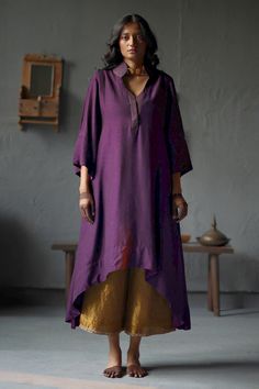 Purple kurta with stitchline embroidered neckline. Paired with red farshi pant.
Component: 2
Type Of Work: Plain
Neckline: Plunge V neck
Sleeve Type: Long sleeves
Fabric: Kurta: Raw Silk, Pant: Cotton Silk, Lining: Shantoon
Color: Purple,Gold
Other Details: 
Side pockets
Note: Dupatta worn by the model is not for sale
Occasion: Puja - Aza Fashions Raw Silk Kurta Designs Women, Cotton Kurta Sets For Women, Shorshe Clothing, Pants Design For Kurti, Latest Suit Design, Satin Kurta, Plain Kurta, Asymmetric Kurta, Red Kurta