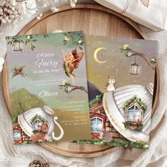 two wedding cards on top of a wooden plate