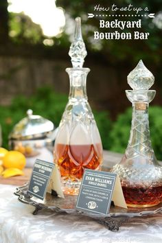 two bottles of bourbon sitting on top of a table