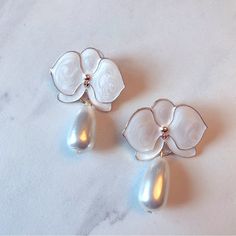 White Orchid Earrings White Flower Earrings Chic White Flower-shaped Earrings, Feminine White Flower Earrings With Pearl Drop, Feminine White Dangle Flower Earrings, Chic White Flower Earrings For Wedding, Chic White Flower Wedding Earrings, Chic Teardrop White Earrings, Chic White Teardrop Earrings, Feminine White Flower Pearl Earrings, Elegant White Pearl Earrings For Spring