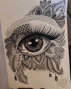 a drawing of an eye with feathers on it