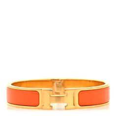 This is an authentic HERMES Enamel Narrow Clic Clac H Bracelet PM in Orange. This chic bracelet is made of gold-plated hardware with a swivel H and features an orange enamel inlay. H Bracelet, Hermes Bracelet, Hermes Jewelry, Chic Bracelet, Christmas List, Plating, Pouch, Things To Sell, Bracelet