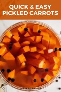 a bowl filled with sliced carrots on top of a white counter next to black pepper