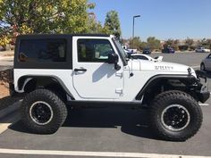 a white jeep parked in a parking lot