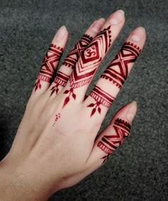 a person's hand with henna tattoos on it