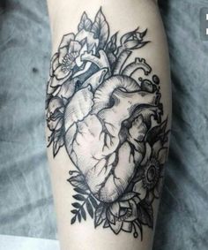 a black and white photo of a heart with roses on it's side tattoo