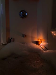 a candle is lit in the middle of a bathtub filled with foam and water