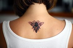 a woman with a bee tattoo on her back