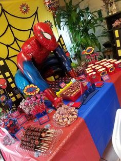 a spiderman themed birthday party with desserts and decorations