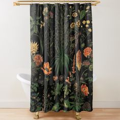 a black shower curtain with colorful flowers and leaves printed on the outside, along with a white bathtub