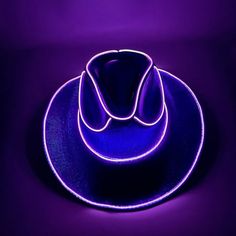 a purple hat is lit up on a black surface with the light reflecting off it's sides