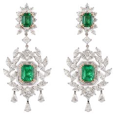 This collection uniquely integrates a geometric Art Deco Style frame with playful tassels from the Mughal era. A sophisticated and classic set made to be passed through generations. Exclusively by Sunita Nahata Fine Design… Art Deco Style Emerald and Diamond Earrings in 18 Karat White and Yellow Gold. Emerald: 1.93 carat, 8.40X6.40mm size, octagon shape. Emerald: 1.85 carat, 8.40X6.40mm size, octagon shape. Emerald: 1.16 carat, 7.10X5.50mm size, octagon shape. Emerald: 1.19 carat, 7.10X5.20mm size, octagon shape. Diamonds: 0.89 carat, 4.50X3.00mm size, Pear shape, G colour, VS clarity. Diamonds: 3.25 carat, 5.00X2.50mm size, Marquise shape, G colour, VS clarity. Diamonds: 0.81 carat, 4.00X2.00mm size, Marquise shape, G colour, VS clarity. Diamonds: 0.81 carat, 2.50mm size, round shape, G c Emerald And Diamond Earrings, Emerald Diamond Earrings, Octagon Shape, Butterfly Pin, Jewel Box, Dream Jewelry, Emerald Diamond, Art Deco Style, Geometric Art