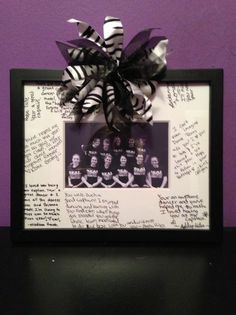 a black and white photo frame with some writing on it that has a ribbon attached to it