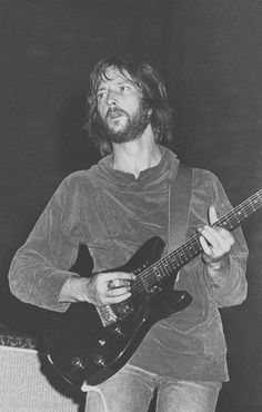 black and white photograph of a man playing an electric guitar