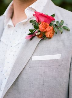 a man in a suit with flowers on his lapel