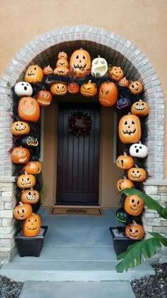 pumpkins are arranged around the entrance to a house