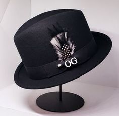 Black wool center crease Lowrider hat 1.5  stingy brim with OG pin and matching  Combo Feather feather dress to impress from Approved OG Apparel Black Lowrider, Hat Fedora, Fashion Closet, Feather Dress, Lowrider, Black Wool, Fedora, Dress To Impress, Wool