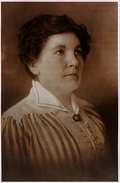 an old black and white photo of a woman wearing a striped shirt with her eyes closed