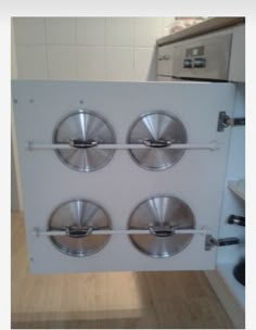 the door is open to reveal four stainless steel plates on each side, in front of an oven