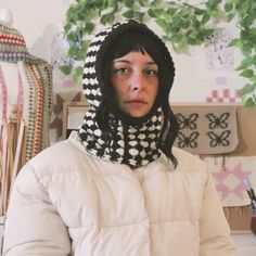 a woman wearing a black and white scarf around her neck