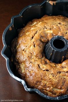 a bundt cake in a metal pan with a black plastic ring on the top