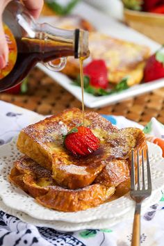 someone is pouring syrup on some french toast