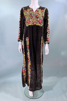 This is an interesting antique embroidered velvet caftan with nice embroidery. The dress is very distressed with threadbare velvet, a few patches, and repairs. The dress is very old. Good for study, display or prop. CONDITION: Poor. Good for study. Well worn, distressed thread bear fabric, a few patches and repairs. SIZE: Refer to measurements for an accurate fit. All sizes are approximate. Shoulder: 17" Underarm: 37" Sleeve: 18" Waist: 42" Length: 50" Mannequin measurements: Size 2, Bust 33" Wa Velvet Bohemian Dress For Holiday Season, Festive Bohemian Velvet Dress, Long Sleeve Velvet Dress With Resham Embroidery, Long Sleeve Velvet Dress For Festivals, Velvet Caftan, Study Well, Bear Fabric, Display Props, Embroidered Velvet