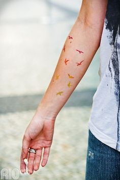 a person with a bird tattoo on their arm