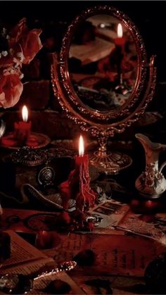 a table topped with candles next to a mirror