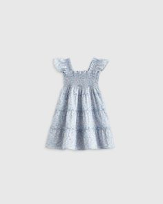 Our 100% Cotton Poplin Smocked Dress embodies comfort and charm. The delicate smocking detail adds a touch of timeless elegance, while the breathable cotton ensures endless hours of play and fun. From tea parties to playdates, it's a must-have for those s Summer Cotton Smocked Dress With Flutter Sleeves, Cotton Tiered Smock Dress, Cotton Smock Tiered Dresses, Floral Print Smocked Dress For Playtime In Summer, Cotton Smocked Dress With Ruffled Straps, Cotton Smocked Dress With Flutter Sleeves And Ruffles, Spring Cotton Smocked Tiered Dress, Spring Cotton Tiered Smocked Dress, Spring Tiered Cotton Smocked Dress