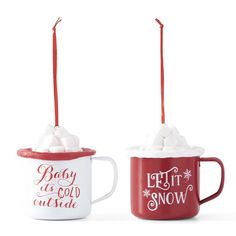 two mugs with hot chocolate and marshmallows in them, one is red and the other white