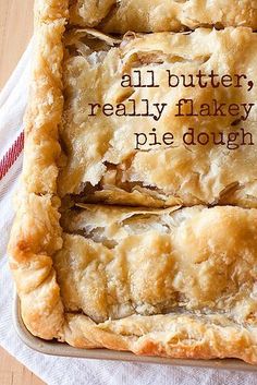 two pieces of pie sitting on top of a wooden table next to a white towel