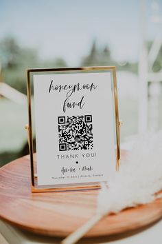 a table with a qr code on it and a white feather sitting next to it