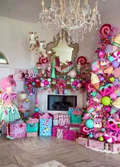 a living room filled with lots of pink and green christmas decorations next to a fire place