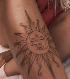 a woman with a sun tattoo on her arm