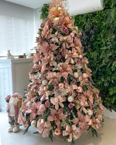 a christmas tree decorated with pink flowers and ornaments