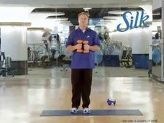 a man standing on top of a metal object in front of a glass wall that says silk