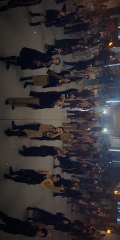 a group of young women standing next to each other in front of a building at night