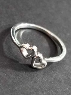 Vintage sterling silver ring. Design on front only. Simple double hearts ring. Stamped 925. The ring band is 1.5mm at the back. The ring is 6mm tall at the front. Our family acquired this ring around 2000, as part of a large jewelry collection. It's in great condition, unworn, antiqued and tarnished. It's been in storage all of these years. This ring would make a nice Mother's Day gift. All vintage sterling silver jewelry may have antiquing or tarnish. Simply polish it with a polishing cloth at Stylish Jewelry Accessories, Teen Ring, Double Heart Ring, Vintage Sterling Silver Jewelry, Friendship Ring, Earth Gift, Geek Jewelry, Friendship Rings, Kids Rings