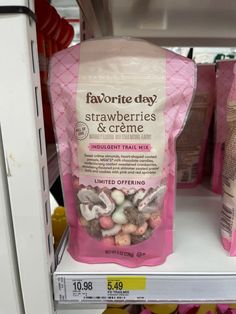 two bags of strawberries and creme sitting on a shelf in a grocery store